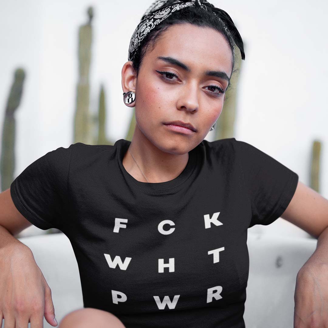 Woman looking at camera wearing t-shirt that reads F C K W H T P W R